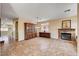 Open-concept living area featuring tile flooring and a stone fireplace at 7920 Aviano Pines Ave, Las Vegas, NV 89129