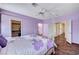Spacious primary suite with a ceiling fan, wood floors, and ensuite bath at 7920 Aviano Pines Ave, Las Vegas, NV 89129