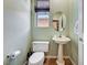 Charming powder room featuring a pedestal sink, window, and neutral color scheme at 7920 Aviano Pines Ave, Las Vegas, NV 89129