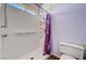 Shower features grab bars, convenient shelving and a colorful purple shower curtain at 7920 Aviano Pines Ave, Las Vegas, NV 89129