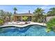 Relaxing backyard featuring a gorgeous pool, firepit, and covered patio at 7986 Merlewood Ave, Las Vegas, NV 89117