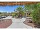Picturesque backyard oasis featuring a pond, cabana, and lush landscaping at 7986 Merlewood Ave, Las Vegas, NV 89117