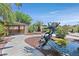 Serene backyard featuring a turtle fountain, tranquil pond, and shaded cabana at 7986 Merlewood Ave, Las Vegas, NV 89117