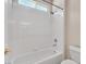 Clean white bathroom featuring a tiled shower-tub combination and neutral walls at 7986 Merlewood Ave, Las Vegas, NV 89117
