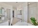 Bright bathroom features a tub, shower, dual sinks, and large mirror at 7986 Merlewood Ave, Las Vegas, NV 89117