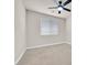 Neutral bedroom with carpeting, ceiling fan, and window creating a bright and simple interior space at 7986 Merlewood Ave, Las Vegas, NV 89117