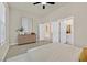 Bright bedroom featuring tile flooring, modern dresser, and ensuite bathroom for a relaxing retreat at 7986 Merlewood Ave, Las Vegas, NV 89117