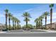 Community entrance with lush palm trees along an inviting street at 7986 Merlewood Ave, Las Vegas, NV 89117