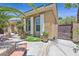 Landscaped yard featuring potted plants, desert landscaping, and wrought iron gate at 7986 Merlewood Ave, Las Vegas, NV 89117