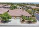 Beautiful home with a well-manicured front yard, two-car garage, and lush landscaping at 7986 Merlewood Ave, Las Vegas, NV 89117