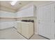Well-organized laundry room with ample counter and cabinet space, plus a washer and dryer set at 7986 Merlewood Ave, Las Vegas, NV 89117