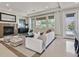 Open-concept living area with fireplace and access to the backyard at 7986 Merlewood Ave, Las Vegas, NV 89117