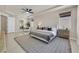 Inviting bedroom with ceiling fan, natural light, sitting area, and ensuite bathroom at 7986 Merlewood Ave, Las Vegas, NV 89117
