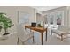 Bright home office with a wooden desk, comfortable seating, and plenty of natural light from the sliding doors at 7986 Merlewood Ave, Las Vegas, NV 89117