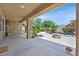 Inviting covered patio with dining area, fire pit, and lush backyard views at 7986 Merlewood Ave, Las Vegas, NV 89117