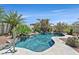 Stunning private pool with rock waterfall and lush tropical landscaping at 7986 Merlewood Ave, Las Vegas, NV 89117