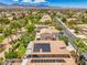 An elevated perspective of a house fitted with solar panels and a manicured landscape in Nevada at 8089 Black Orchid Ave, Las Vegas, NV 89131