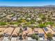An expansive aerial view of a residential neighborhood with neatly arranged homes and tree-lined streets under a clear blue sky at 8089 Black Orchid Ave, Las Vegas, NV 89131