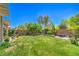 Spacious backyard featuring a lush lawn, mature trees, and well-maintained landscaping, ideal for outdoor activities at 8089 Black Orchid Ave, Las Vegas, NV 89131