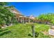 Lush backyard with green lawn, mature trees, and garden beds creates a serene outdoor living space at 8089 Black Orchid Ave, Las Vegas, NV 89131