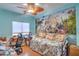 Bedroom with fun mural, ceiling fan, hardwood floors, and ample light at 8089 Black Orchid Ave, Las Vegas, NV 89131