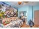 Bedroom with fun mural, hardwood floors, closet, and ample light at 8089 Black Orchid Ave, Las Vegas, NV 89131