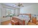 Inviting bedroom with a ceiling fan, window views, and wood furnishings at 8089 Black Orchid Ave, Las Vegas, NV 89131