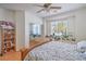 Bright bedroom with wood floors, ceiling fan, and mirrored closet doors at 8089 Black Orchid Ave, Las Vegas, NV 89131