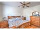 Comfortable bedroom with wood furnishings, ceiling fan and natural light at 8089 Black Orchid Ave, Las Vegas, NV 89131