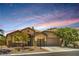 Charming single-story home featuring desert landscaping, an attached garage, and a warm, inviting facade at 8089 Black Orchid Ave, Las Vegas, NV 89131