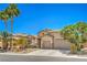 Charming single-story home featuring desert landscaping, an attached garage, and a warm, inviting facade at 8089 Black Orchid Ave, Las Vegas, NV 89131