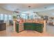 Open kitchen and dining area with tiled floors and green cabinets at 8089 Black Orchid Ave, Las Vegas, NV 89131