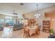 Inviting open-concept living and dining area featuring tile floors, high ceilings, and natural light from large windows at 8089 Black Orchid Ave, Las Vegas, NV 89131