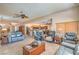 Open-concept living space featuring tile flooring, plush furniture, and a view into the kitchen and dining areas at 8089 Black Orchid Ave, Las Vegas, NV 89131