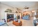 Spacious living area with a media center, fireplace, tile flooring, and comfortable seating, perfect for entertaining at 8089 Black Orchid Ave, Las Vegas, NV 89131