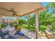 Covered patio area overlooks a spacious backyard with lush landscaping, perfect for outdoor relaxation and entertaining at 8089 Black Orchid Ave, Las Vegas, NV 89131