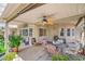 Covered patio with ceiling fan, seating, and view of the backyard at 8089 Black Orchid Ave, Las Vegas, NV 89131