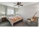 Comfortable bedroom with a ceiling fan, a cozy chair with a guitar, and natural light from the window at 914 Appaloosa Hills Ave, North Las Vegas, NV 89081
