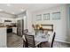 Charming dining area adjacent to the kitchen with stainless steel appliances and warm lighting at 914 Appaloosa Hills Ave, North Las Vegas, NV 89081