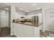 Bright kitchen featuring white cabinets, stainless steel appliances, and a bar-style counter at 914 Appaloosa Hills Ave, North Las Vegas, NV 89081