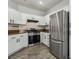 Well-lit kitchen with white cabinetry, stainless steel refrigerator, and modern appliances at 914 Appaloosa Hills Ave, North Las Vegas, NV 89081