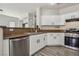 Modern kitchen featuring stainless steel appliances, granite countertops, and sleek white cabinetry at 914 Appaloosa Hills Ave, North Las Vegas, NV 89081