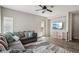Comfortable living room featuring a plush sectional sofa, ceiling fan, and stylish decor at 914 Appaloosa Hills Ave, North Las Vegas, NV 89081
