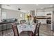Open-concept living space featuring dining area, kitchen, and comfortable living area at 914 Appaloosa Hills Ave, North Las Vegas, NV 89081