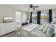 Spacious main bedroom features a tufted bed, natural light, and access to an ensuite bathroom at 914 Appaloosa Hills Ave, North Las Vegas, NV 89081