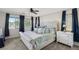 Main bedroom featuring a tufted bed, dual nightstands, and ample natural light at 914 Appaloosa Hills Ave, North Las Vegas, NV 89081