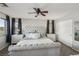 Bright main bedroom with a tufted bed, dual nightstands, and closet at 914 Appaloosa Hills Ave, North Las Vegas, NV 89081