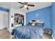 Bedroom featuring a ceiling fan, window view, wood-style flooring and a closet at 9141 Careful Canvas Ave, Las Vegas, NV 89149