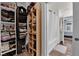 Closet space with shelving to the left and featuring a bathroom with tub and shower straight ahead at 9141 Careful Canvas Ave, Las Vegas, NV 89149