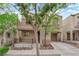 View of a charming two-story house with a front porch, balcony, single-car garage, and neatly maintained yard at 9141 Careful Canvas Ave, Las Vegas, NV 89149